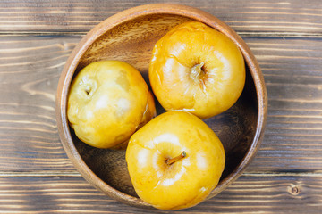 pickled apples from the wooden barrels in wooden bowl.