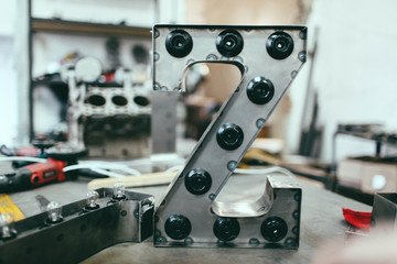 metal letter Z with led light bulbs isolated on interesting background