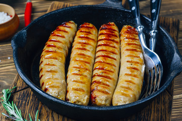 Tyrolean sausages with rosemary in a cast iron pan