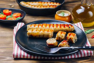 Tyrolean sausages with rosemary in a cast iron pan