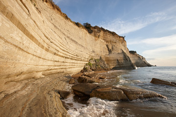 Fototapeta na wymiar Beautiful coastline with cliffs in Corfu, Greece. Unique geological formations in Peroulades region.