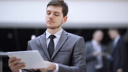 portrait of handsome businessman on blurred office background