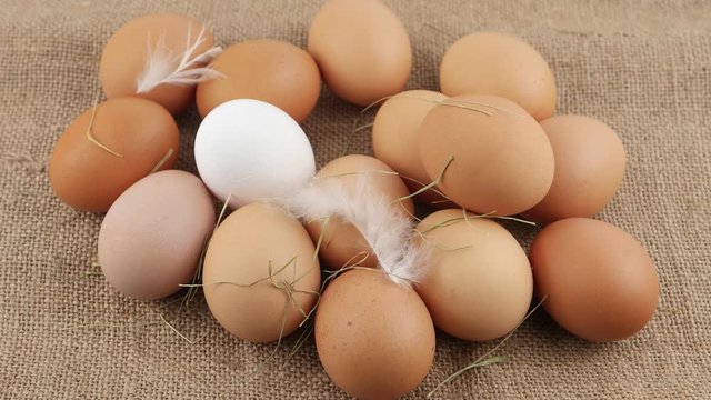 Raw eggs lie on a piece of burlap, background