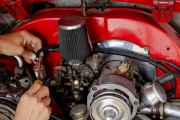 Close up of car machine, man hand checking the mechanic by screwdriver at the mechanical workshop
