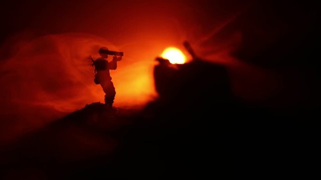 Military soldier silhouette with bazooka. War Concept. Military silhouettes fighting scene on war fog sky background, Soldier Silhouette aiming to the target at night. Attack scene