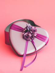 Heart-shaped gift box decorated with flower and ribbons