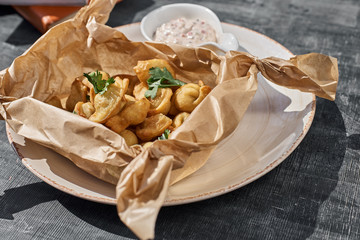 Fried small dumplings in a ceramic plate on a table