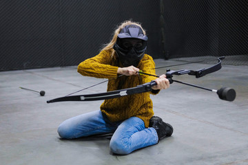 Girl with crossbow arrows bow. The Archer takes aim, sharpshooter. Crossbow club.