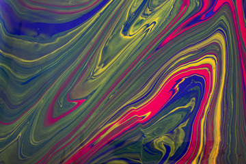 Abstract background with psychedelic vivid colors. Marbleized bright effect with fluid painting, background for wallpapers, poster, postcard. Swirls and lines with yellow, blue, purple and magenta.