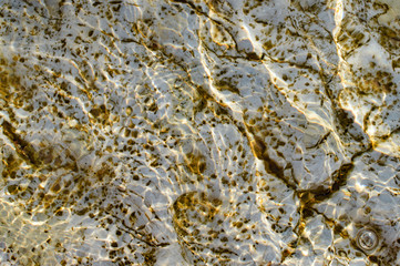 Stones and pebbles under water.