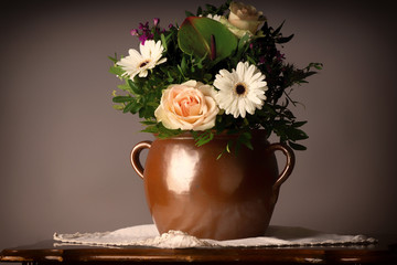 bouquet of flowers, on old coffee-table with old ceramic vase