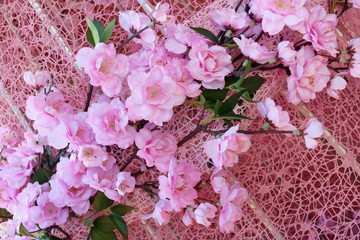 Plastic Easter flowers of pink cherry as part of a decorative installation