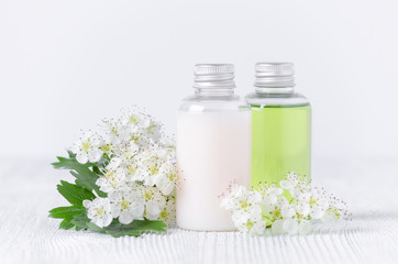 Obraz na płótnie Canvas bottles of natural shower gel and shampoo with plants