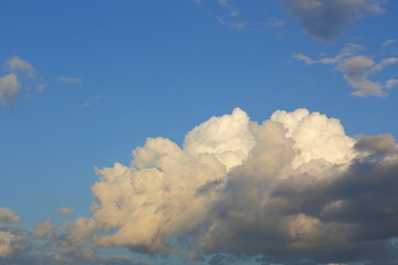 large rain cloud on clear blue sky background