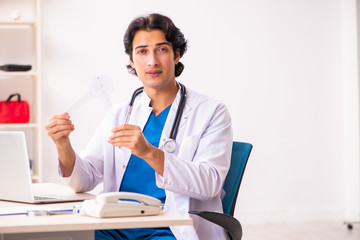 Young male doctor with goniometer