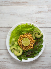 Fresh organic chickpeas and avocado salad flat lay