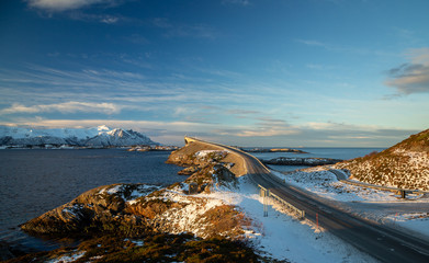 Atlantic Ocean Road in winter sunny day. Famous high bridge over the sea.
