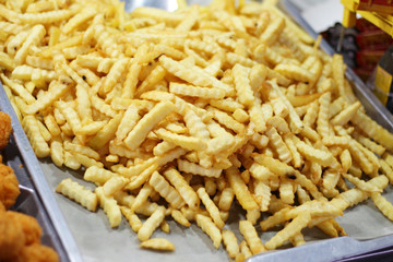 fried potatoes as background at market in Thailand