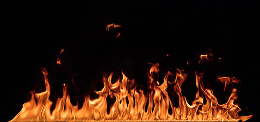 Texture of fire wall isolated on a black background.