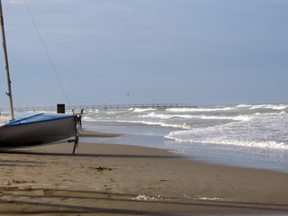 Sandy beach on the Adriatic coast, Rimini, Italy.  The East wind drives the long waves.
