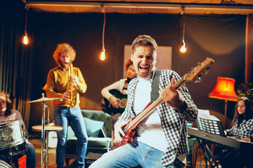Multicultural jazz band practicing for the gig in home studio.