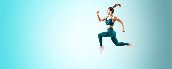 Fototapeta na wymiar Young woman runner in blue sportswear jump in the air.
