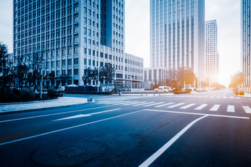 Fototapeta premium city empty traffic road with cityscape in background.