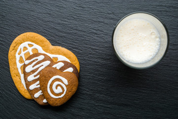 Concept Valentine's Day. Heart-shaped cookies with the pattern of the glaze on a stone table. Top view. Copy space.