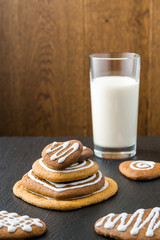St. Valentine's style handmade cookies with fresh healthy milk in the glass on the stone table with the wooden background