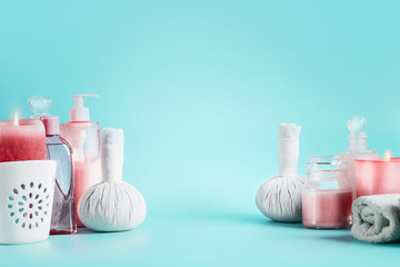 Spa background with beauty tools : cream, towels, serum, burning candles, lotion , standing on pastel blue table. Salon wellness therapy treatments and equipment. Healthy lifestyle  concept. Banner