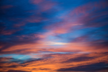  Sunset sky with clouds. Golden sunlight  for your idea of web header. Cloudy landscape for background in serenity colors - blue, violet, yellow and pink tone.