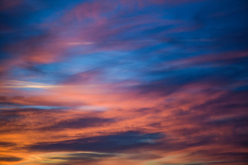  Sunset sky with clouds. Golden sunlight  for your idea of web header. Cloudy landscape for background in serenity colors - blue, violet, yellow and pink tone.