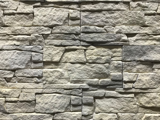 Old vintage grey wall made of craft stones