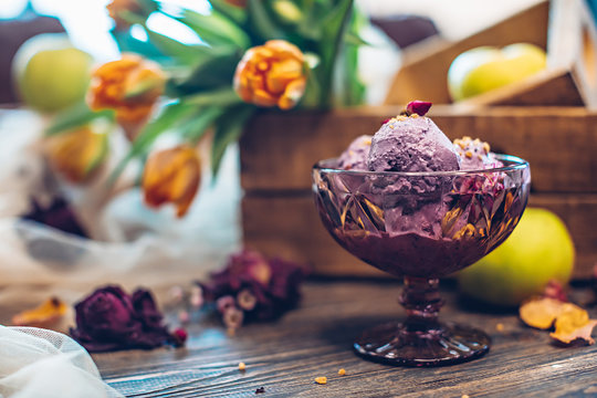 Lilac ice cream with nuts decorated with flowers