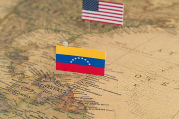 Flags of the USA and Venezuela on the world map. Conceptual photo, politics and world order
