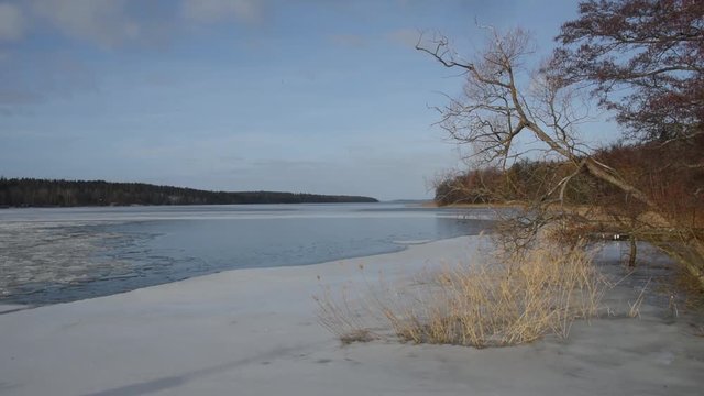 Winter view at the lake Malaren, Stockholm, shifting sun light and moving clouds