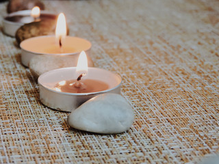 Spa treatments. Beautiful spa composition with  flowers on table close up. Spa still life with aromatic candles,candle background light  table relaxation spa beauty aromatherapy luxury closeup.