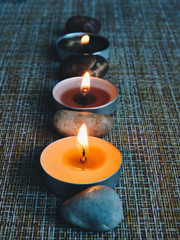 Spa treatments. Beautiful spa composition with  flowers on table close up. Spa still life with aromatic candles,candle background light  table relaxation spa beauty aromatherapy luxury closeup.