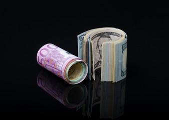 European paper money and us dollars in rolls