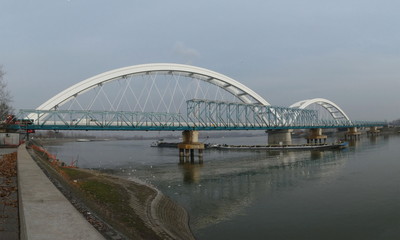 Fototapeta na wymiar Old and new bridge over the Danube river with tugboat under