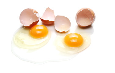 Cracked eggs, eggshells with yolk isolated on white background