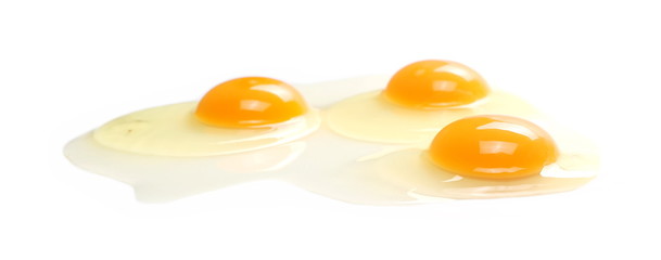 Raw eggs with yolks isolated on white background