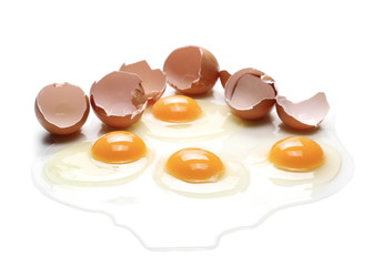 Cracked eggs, eggshells with yolk isolated on white background