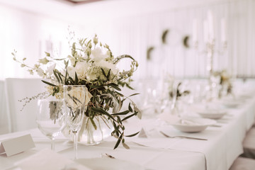 Wedding table decorated with bouquet and candles
