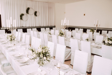 Wedding table decorated with bouquet and candles