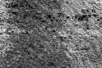 Textured uneven stone surface. Gray limestone. The surface is formed by sawing blocks. Background image. Construction material.