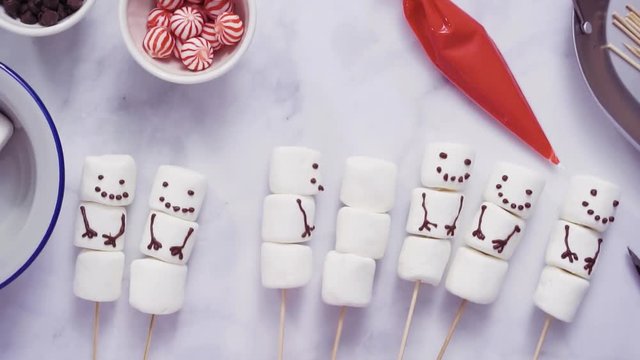 Step by step. Flat lay. Making marshmallow snowman and reindeer on sticks hot chocolate toppers for food gifting.