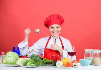 Woman professional chef hold spoon with raw mushroom. Dieting concept. Girl wear hat and apron try mushroom taste. Healthy vegetarian and vegan recipes. Healthy raw food. Eat healthy. Healthy ration