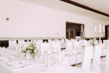 Wedding table decorated with bouquet and candles
