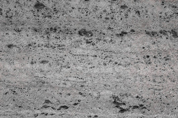 Textured uneven stone surface. Gray limestone. The surface is formed by sawing blocks. Background image. Construction material.